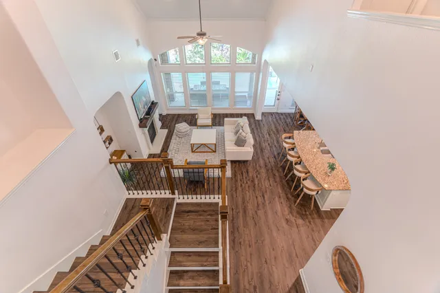 a living room with furniture a ceiling fan and a window
