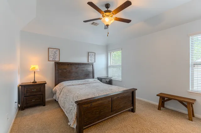 a bedroom with a bed and a dresser