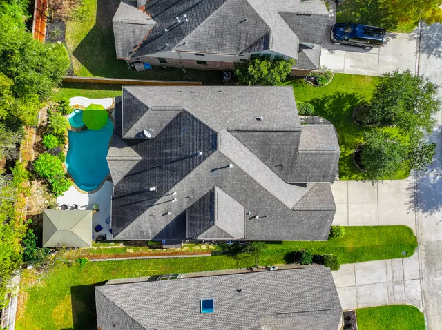 an aerial view of a house with a garden and yard