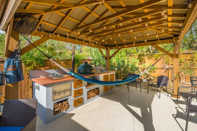 a view of a patio with table and chairs