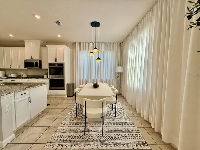 a view of a living room with kitchen