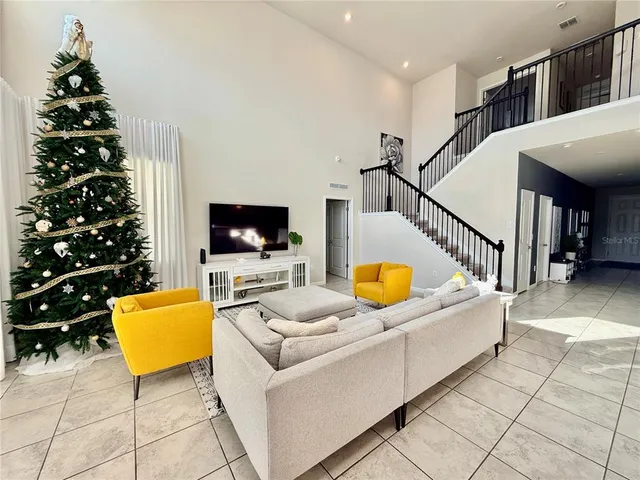 a bedroom with furniture and a flat screen tv