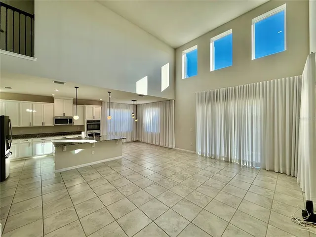 a view of a room with furniture and a ceiling fan