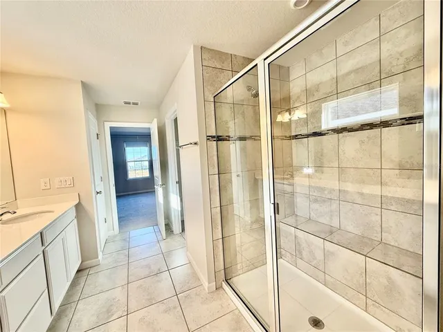 an aerial view of a house with a garden and houses