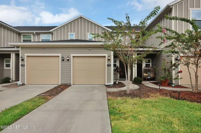 a view of a house with a yard and garage