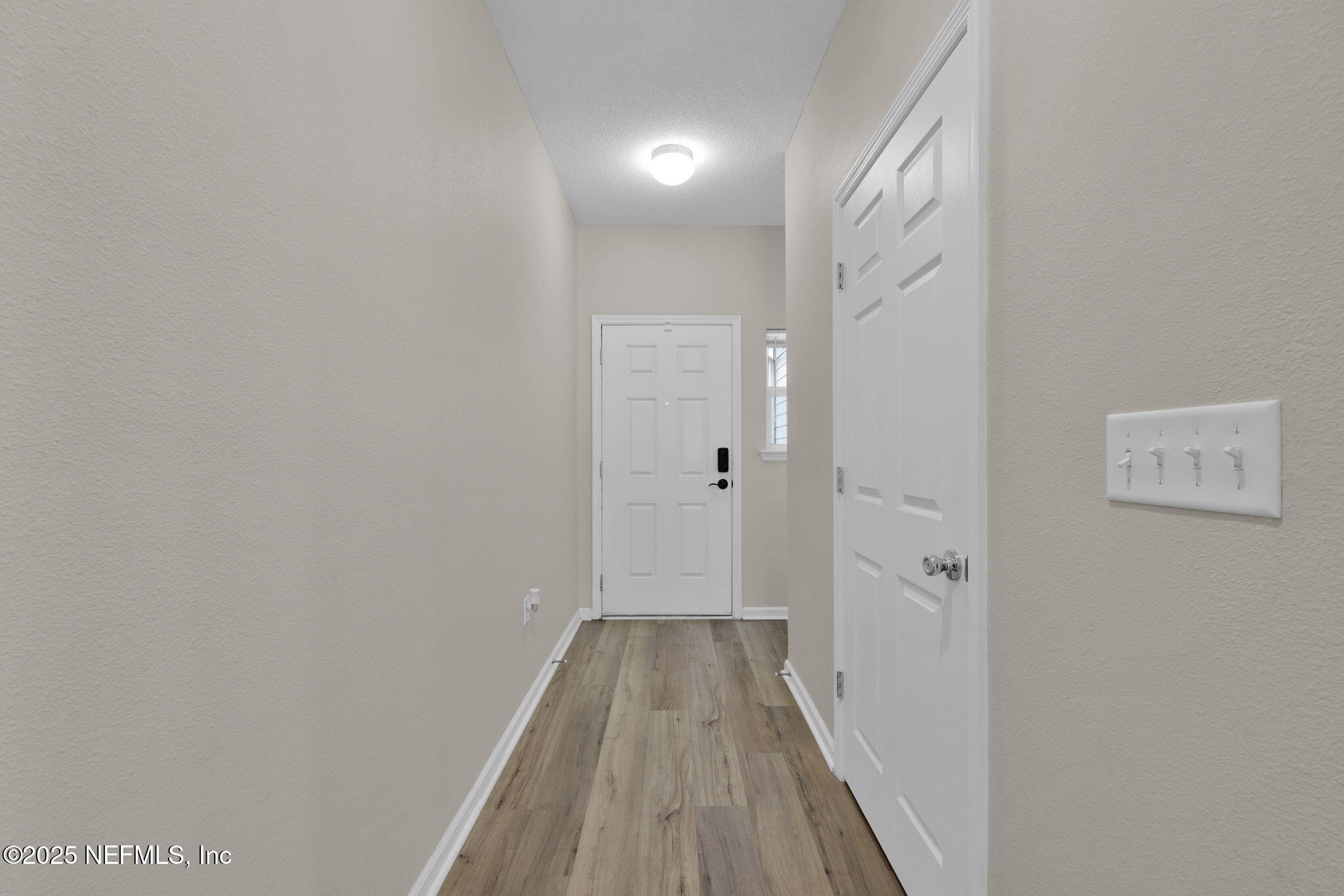 7791 Merchants Way Jacksonville, FL 32222 - Photo 3 of 21 a view of a hallway with wooden floor