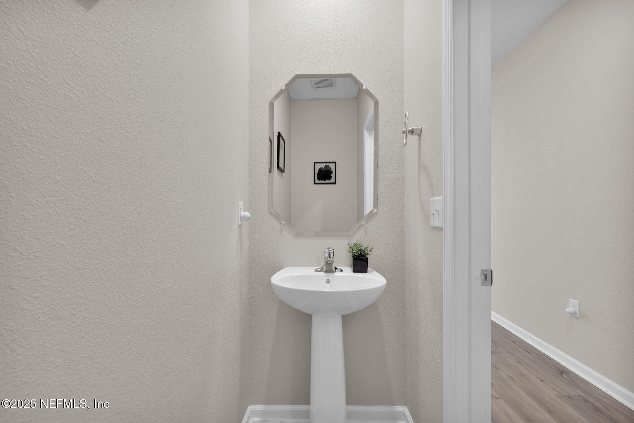 7791 Merchants Way Jacksonville, FL 32222 - Photo 4 of 21 a bathroom with a sink and a mirror
