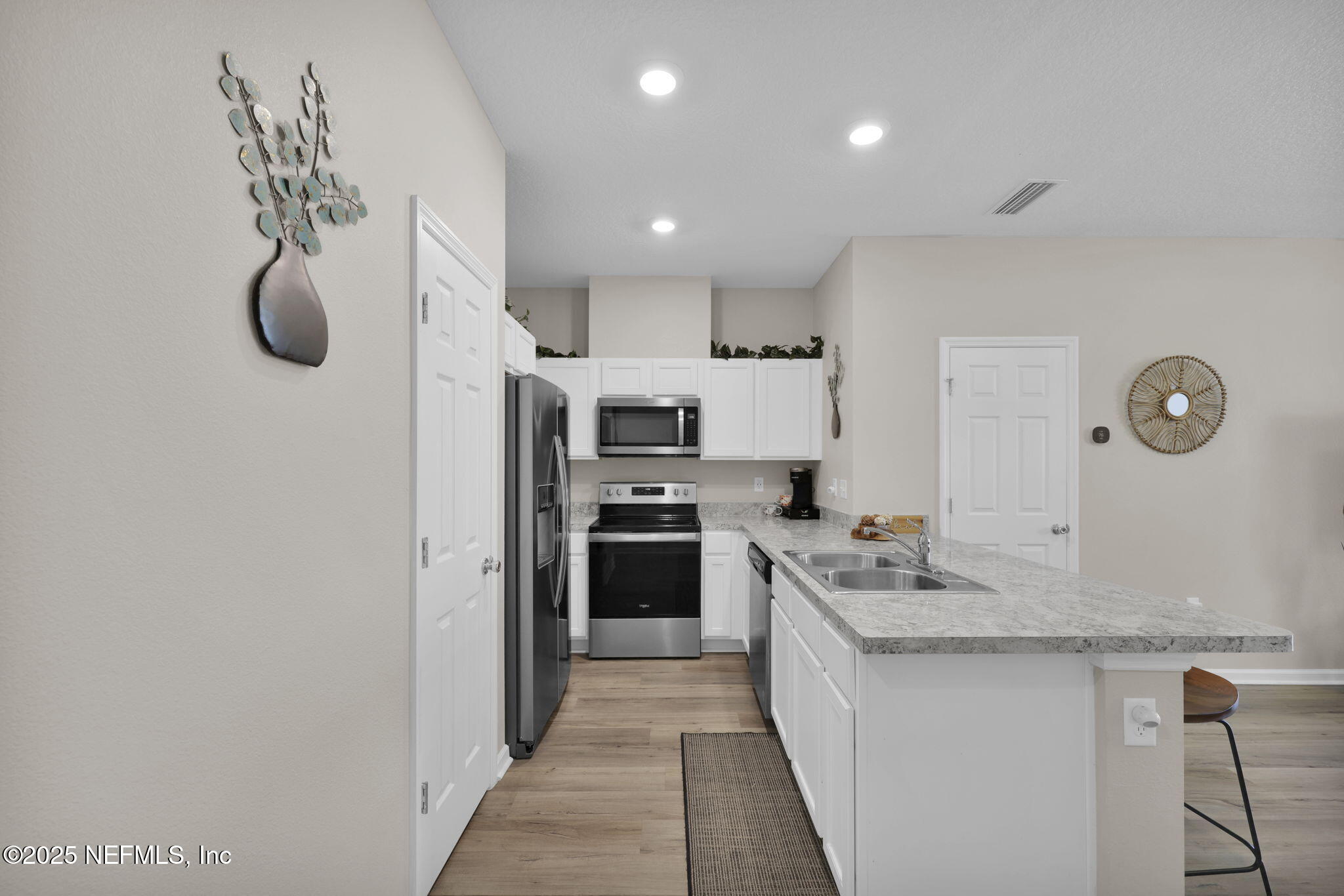 7791 Merchants Way Jacksonville, FL 32222 - Photo 6 of 21 a large kitchen with stainless steel appliances granite countertop a sink and cabinets