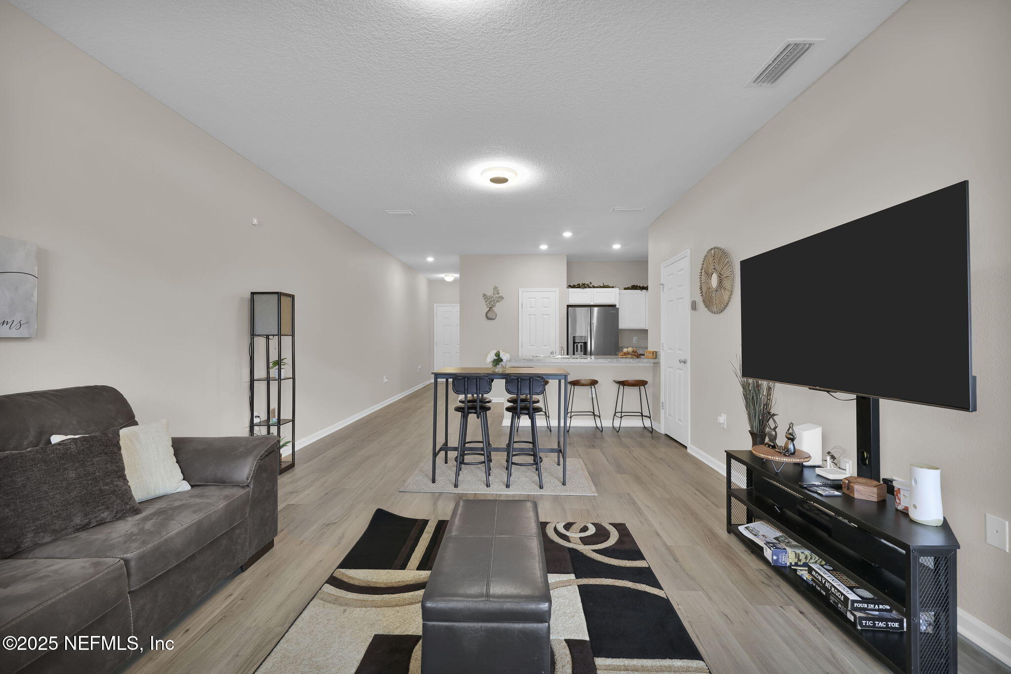 7791 Merchants Way Jacksonville, FL 32222 - Photo 10 of 21 a living room with furniture and a flat screen tv