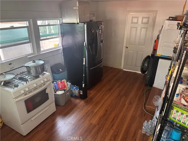 a kitchen with wooden floors and appliances