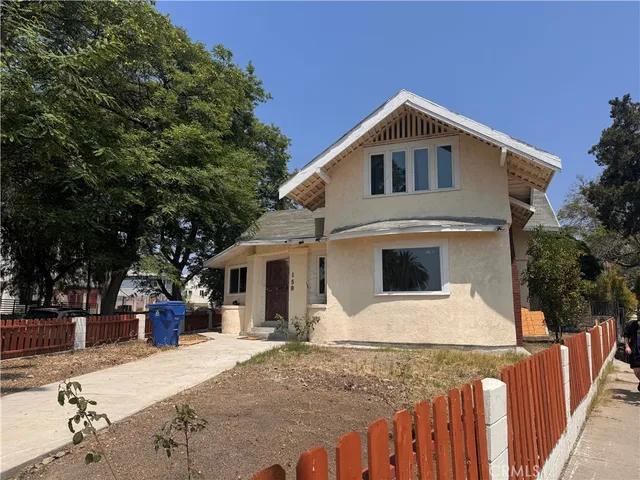 a front view of house with yard garage and trees