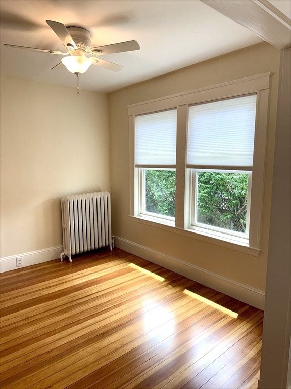 39 Newman Road Malden, MA 02148 - Photo 5 of 27 a view of an empty room with wooden floor and a window