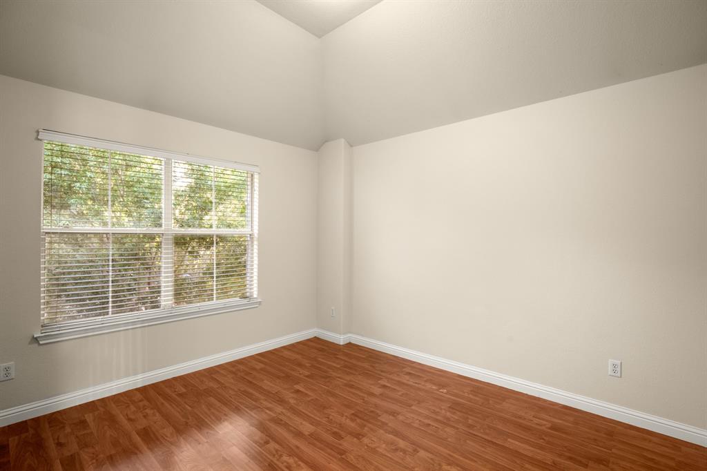 10105 Wind Cave Trail Austin, TX 78747 - Photo 18 of 23 Room featuring vaulted ceilings and wood-finish flooring