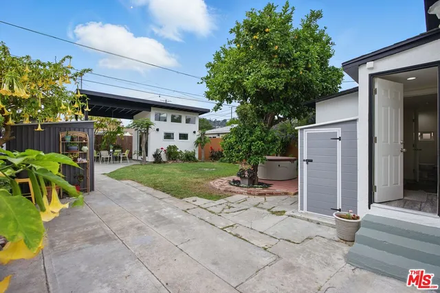 a view of a patio with a table and chairs under an umbrella