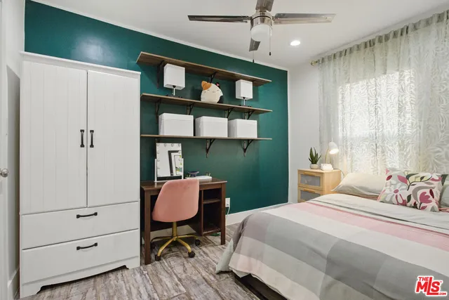 a bedroom with a bed dresser and a window