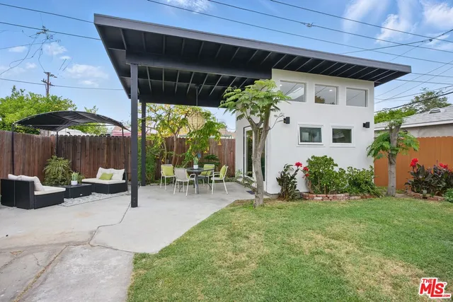a view of a patio with a table and chairs under an umbrella