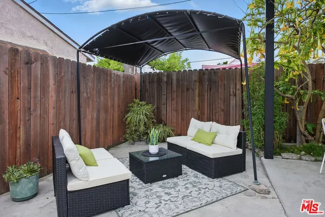 a view of patio with a table and chairs under an umbrella