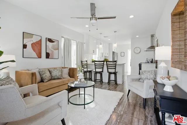 a living room with furniture and kitchen view