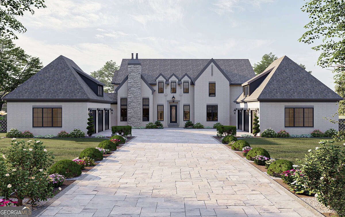 a front view of a house with a garden and plants