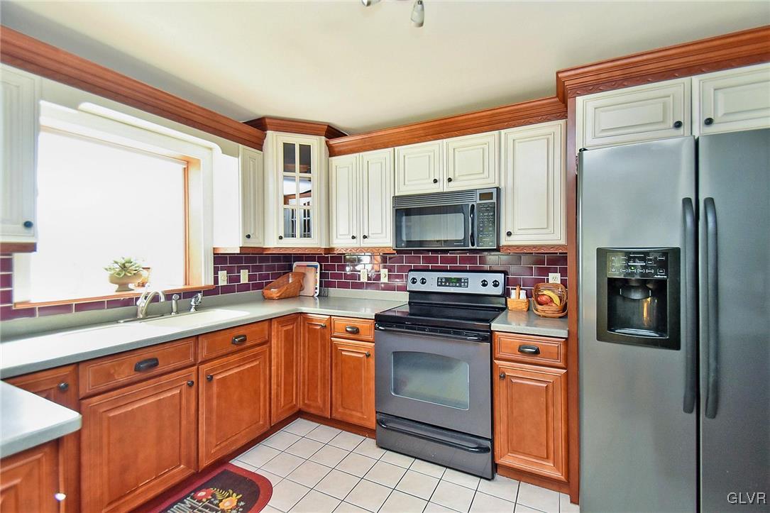 2421 Yost Road Bath, PA 18014 - Photo 6 of 31 a kitchen with stainless steel appliances a stove sink and refrigerator