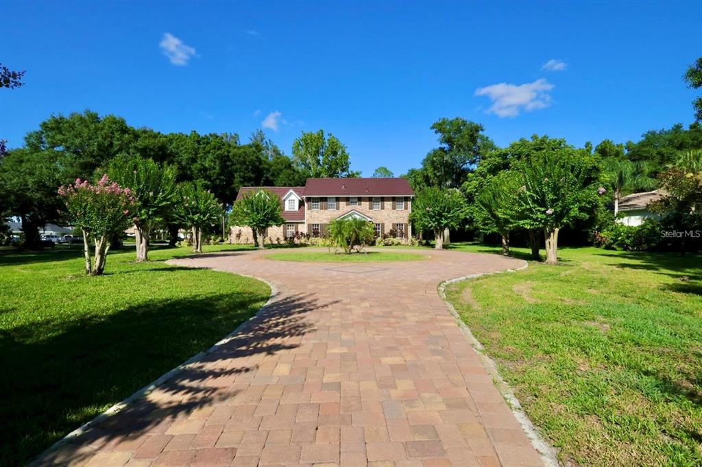 a view of house with garden space and trees