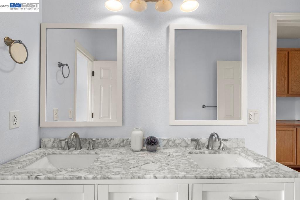 3400 Fallen Oak Drive Modesto, CA 95355 - Photo 16 of 59 a bathroom with sinks granite countertop and a mirror
