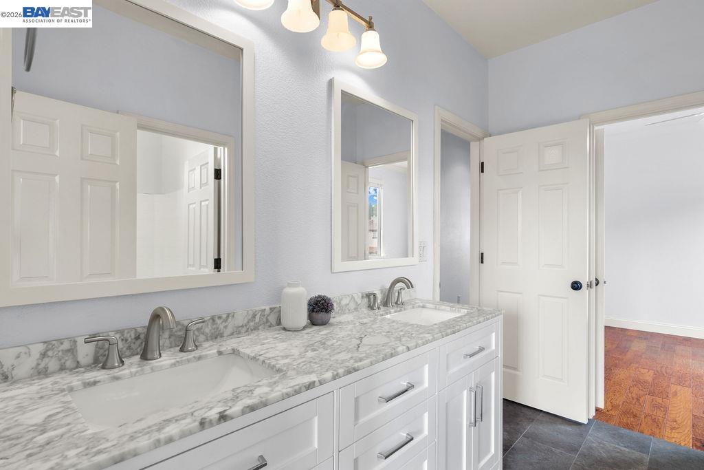 3400 Fallen Oak Drive Modesto, CA 95355 - Photo 17 of 59 a bathroom with a granite countertop sink and a mirror