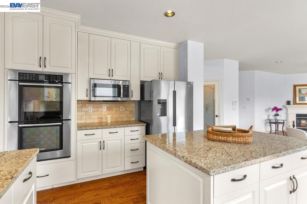 3400 Fallen Oak Drive Modesto, CA 95355 - Photo 7 of 59 a kitchen with stainless steel appliances granite countertop a sink stove and refrigerator