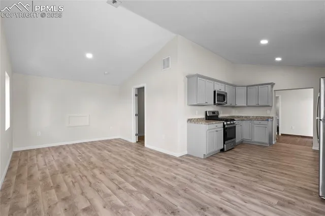 a view of kitchen with granite countertop cabinets and white appliances