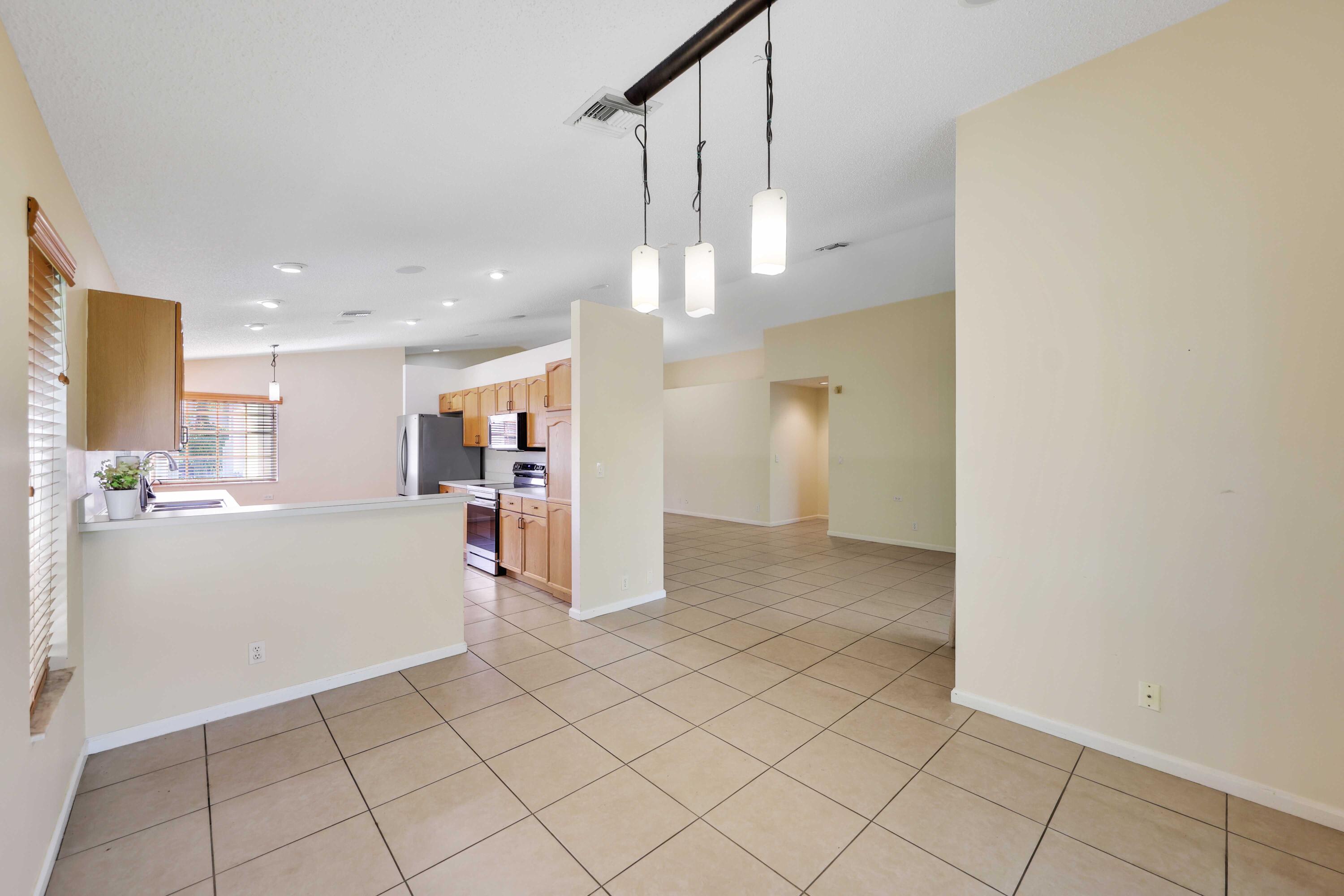 5125 Columbo Court Delray Beach, FL 33484 - Photo 25 of 60 a view of a kitchen and a refrigerator in a kitchen