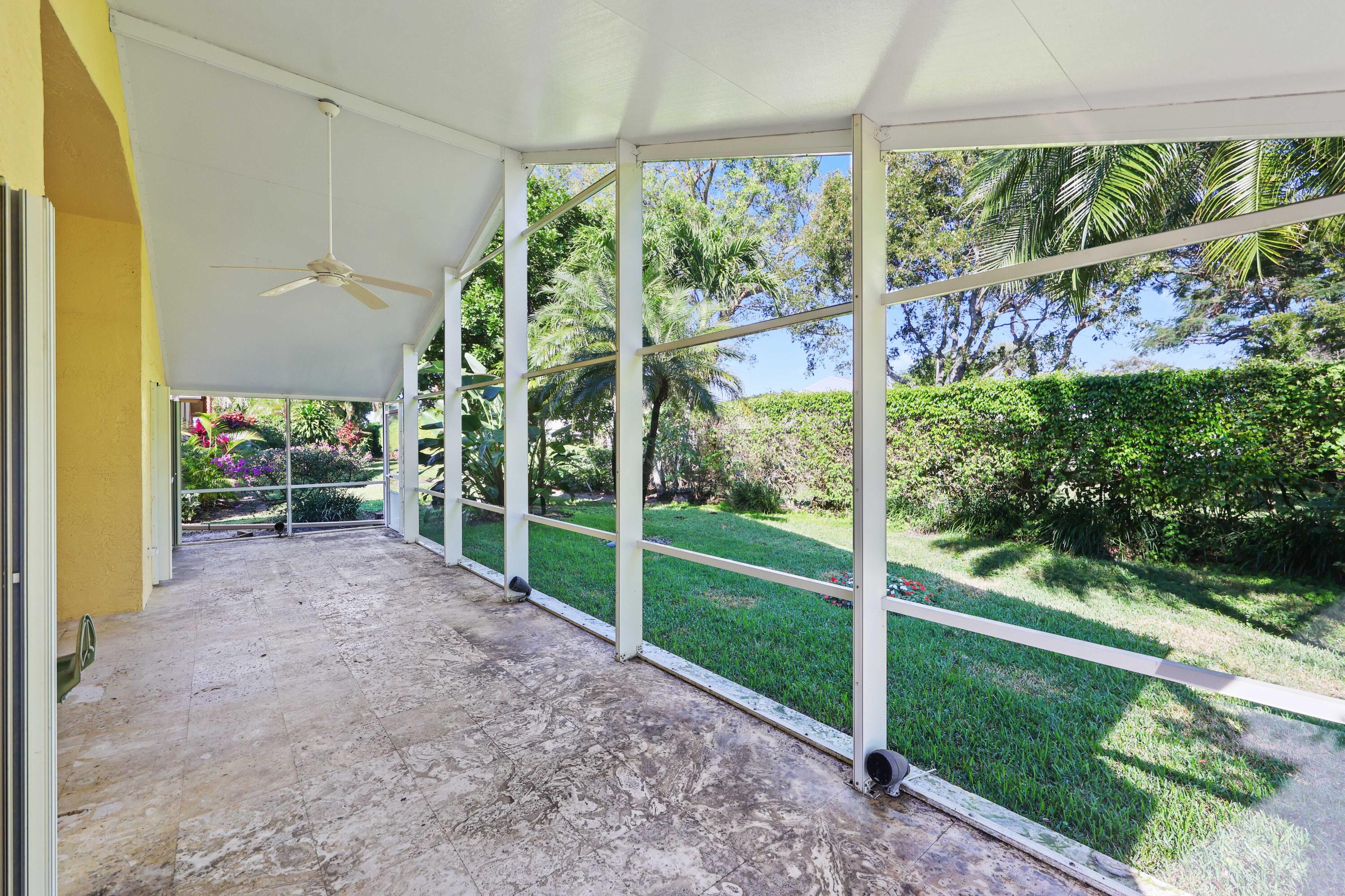 5125 Columbo Court Delray Beach, FL 33484 - Photo 41 of 60 a view of a porch with furniture and garden