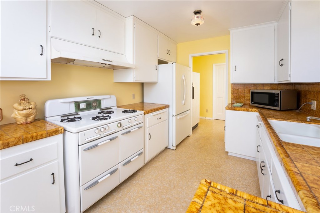 219 Esplanade San Clemente, CA 92672 - Photo 15 of 63 a kitchen with cabinets appliances and a counter space