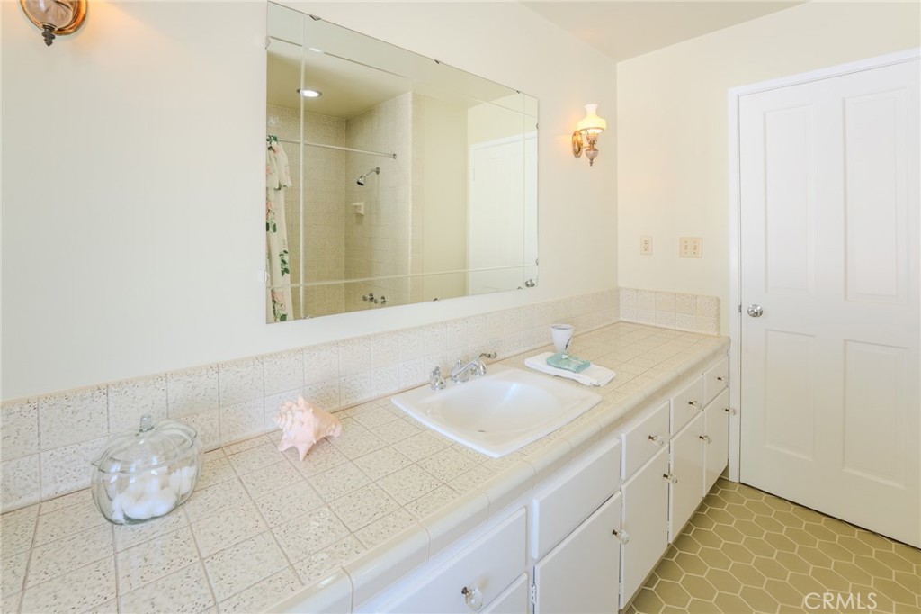 219 Esplanade San Clemente, CA 92672 - Photo 24 of 63 a bathroom with a granite countertop sink and a mirror