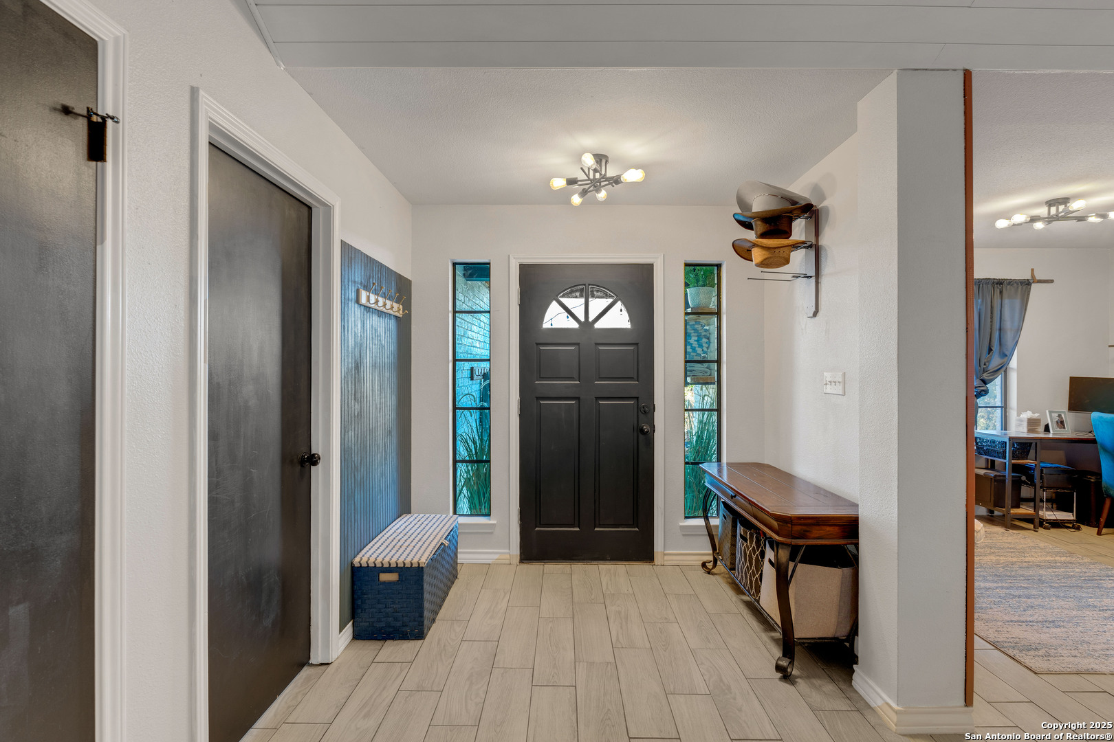 2665 Casey Road Bulverde, TX 78163 - Photo 12 of 42 a view of a hallway with wooden floor and furniture