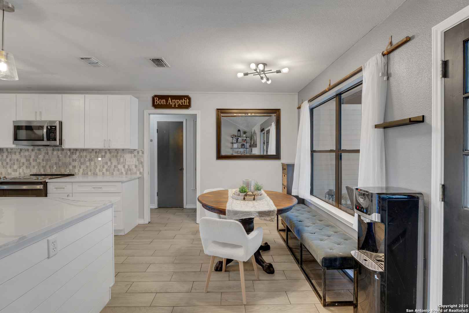 2665 Casey Road Bulverde, TX 78163 - Photo 19 of 42 a view of a dining room with furniture and wooden floor