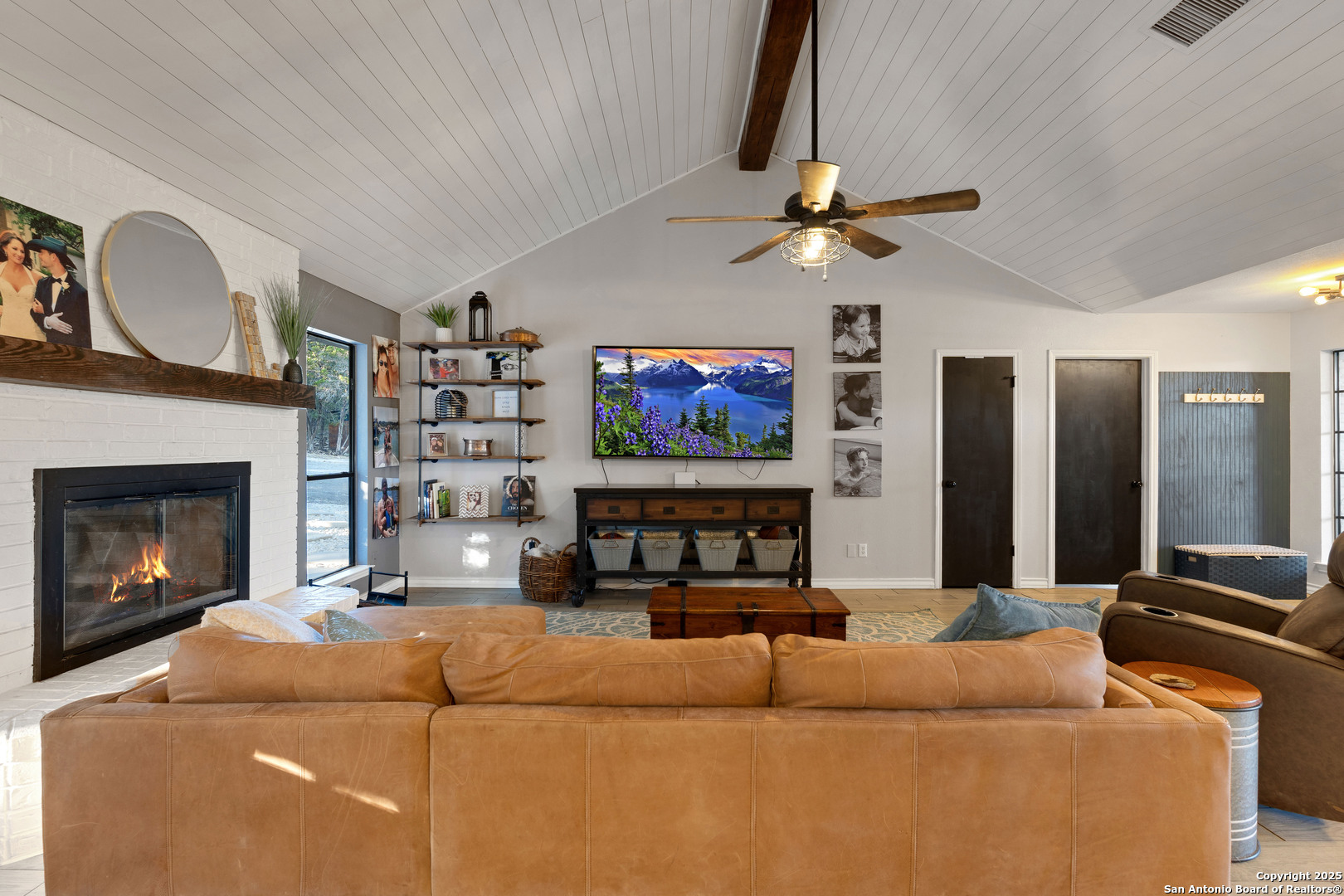 2665 Casey Road Bulverde, TX 78163 - Photo 22 of 42 a living room with furniture a ceiling fan and a fireplace