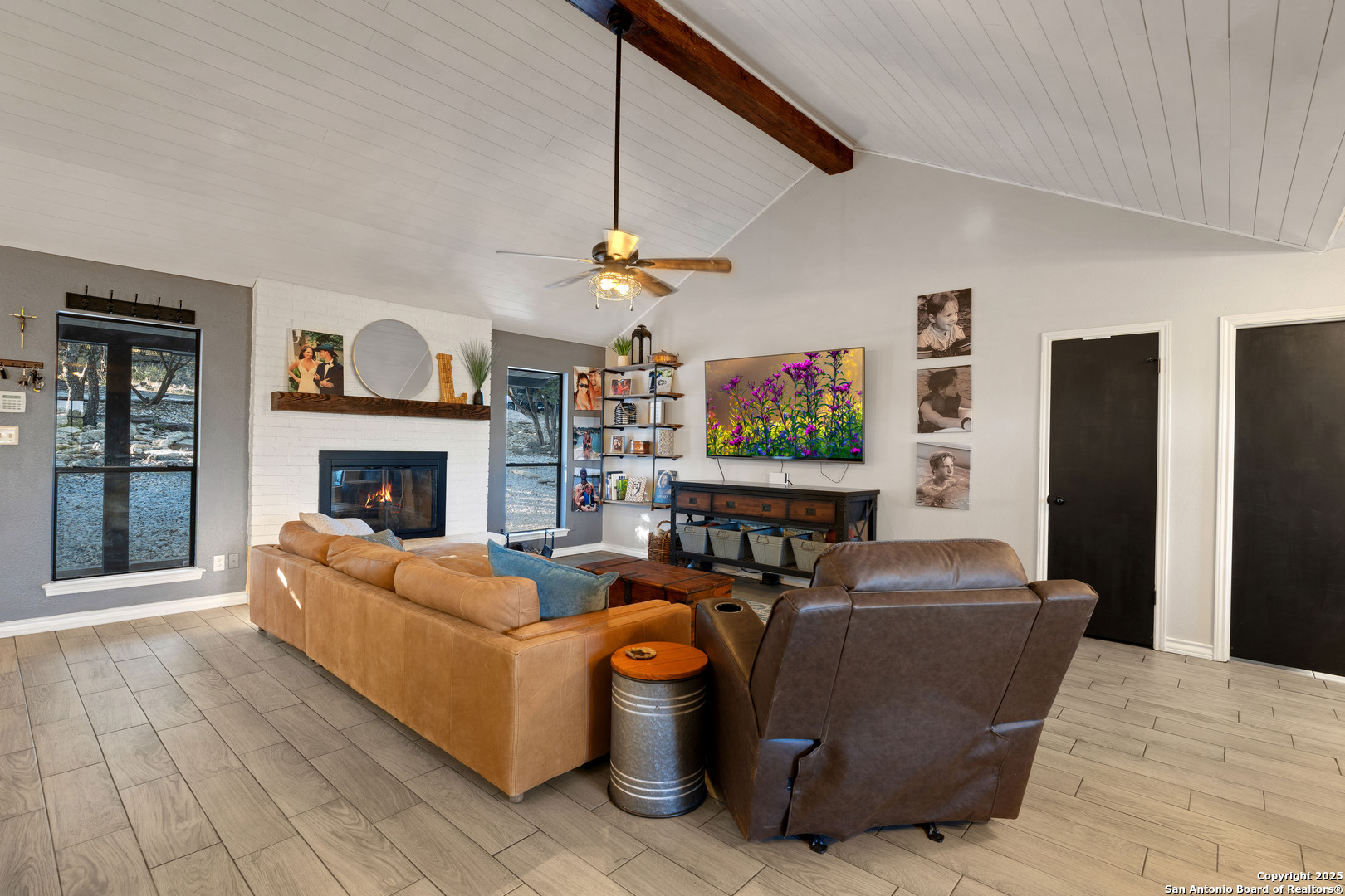2665 Casey Road Bulverde, TX 78163 - Photo 23 of 42 a living room with furniture a flat screen tv and a fireplace