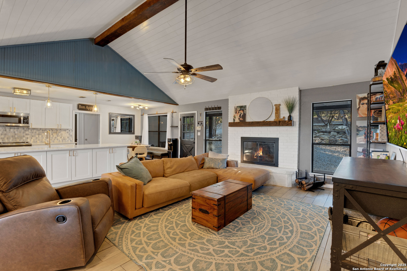 2665 Casey Road Bulverde, TX 78163 - Photo 25 of 42 a living room with furniture a fireplace and a flat screen tv