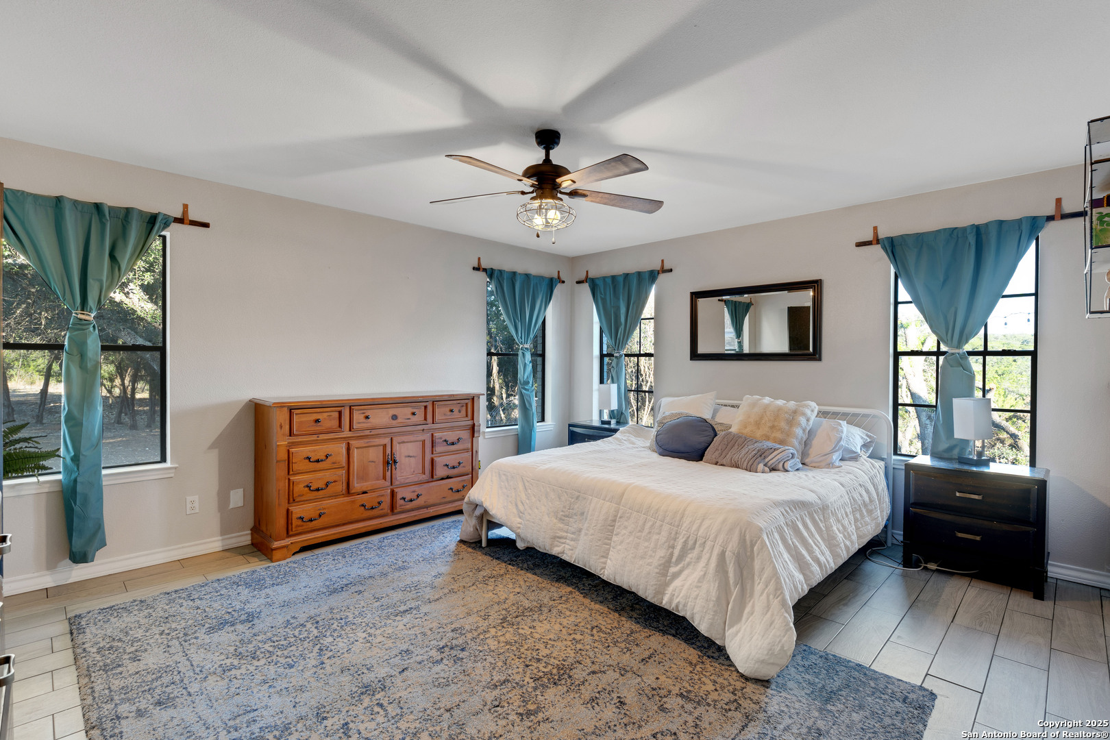 2665 Casey Road Bulverde, TX 78163 - Photo 28 of 42 a bedroom with a large bed and dresser