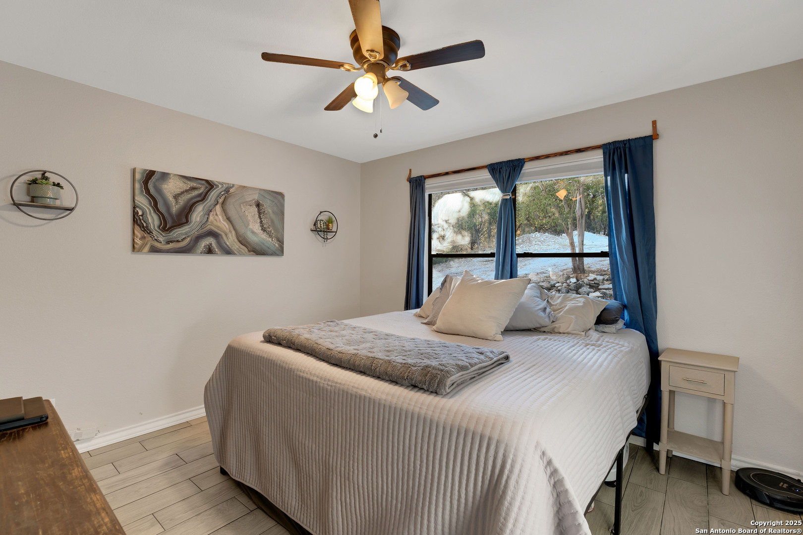 2665 Casey Road Bulverde, TX 78163 - Photo 36 of 42 a bedroom with a large bed and a chandelier