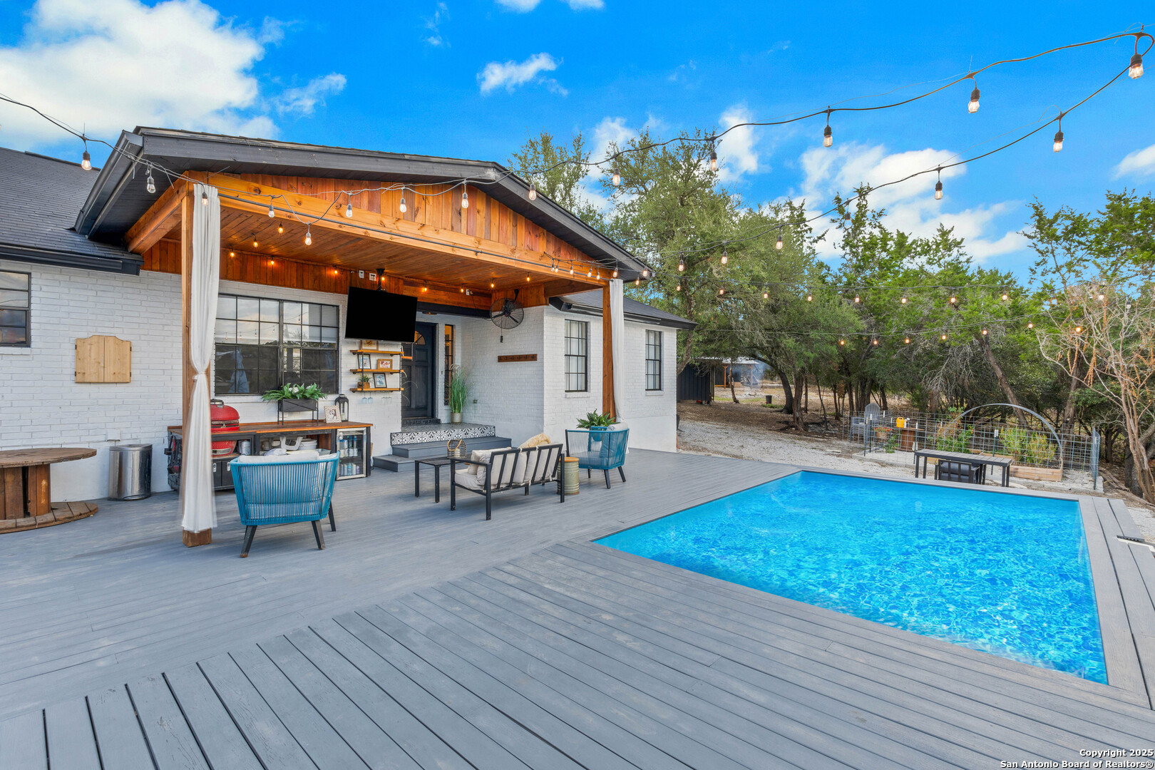 2665 Casey Road Bulverde, TX 78163 - Photo 6 of 42 a view of a patio with table and chairs with wooden floor and fence