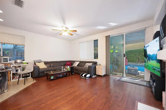 a living room with furniture fireplace and flat screen tv