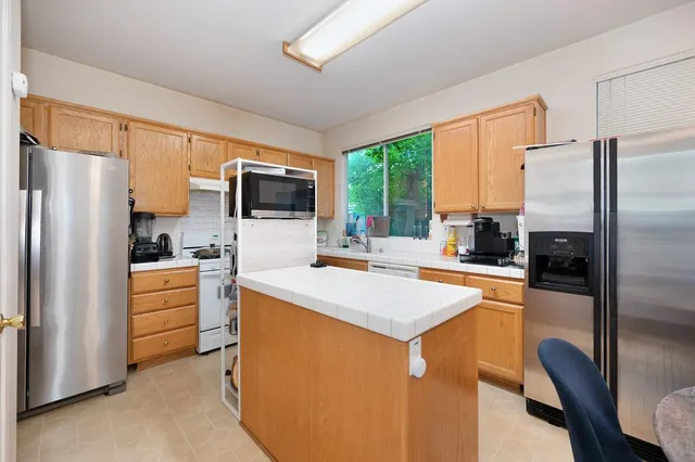 a bedroom with a bed and a flat tv screen on dresser