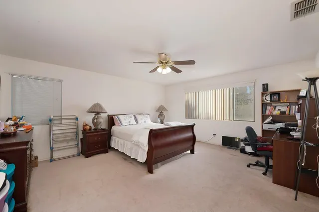 a white bath tub sitting next to a shower