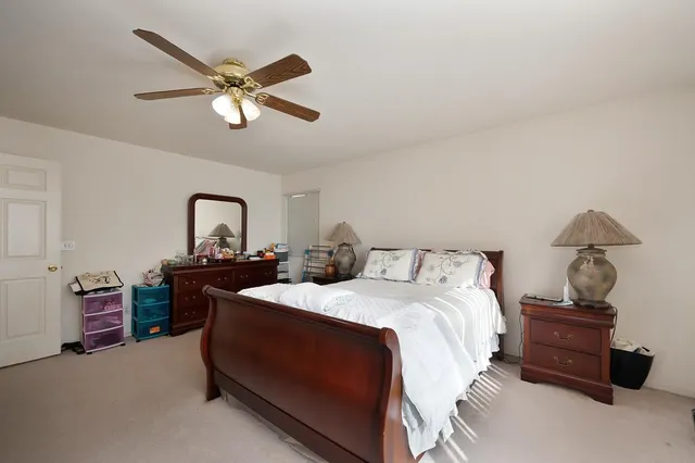 a bedroom with a bed and a desk