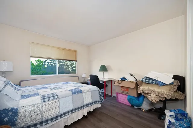 a view of a swimming pool with a porch and furniture