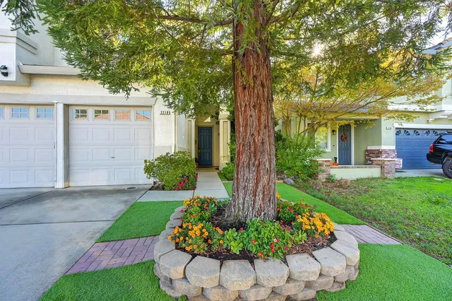 a view of a pathway with a house in front of main door