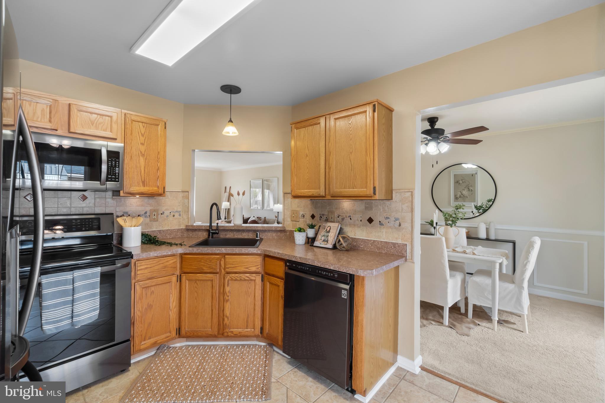 4402 Cole Farm Road Nottingham, MD 21236 - Photo 13 of 42 a kitchen with a sink stainless steel appliances and cabinets