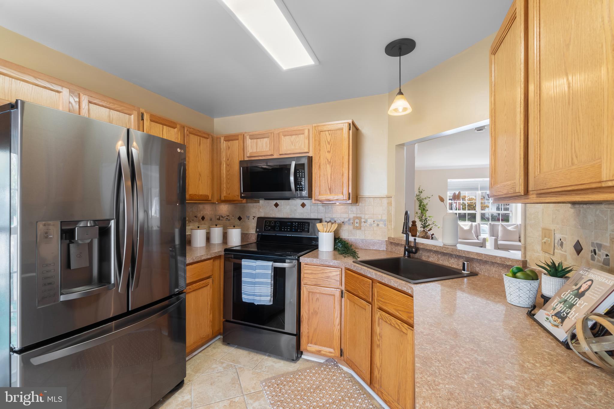 4402 Cole Farm Road Nottingham, MD 21236 - Photo 14 of 42 a kitchen with stainless steel appliances granite countertop a refrigerator a stove top oven a sink and dishwasher