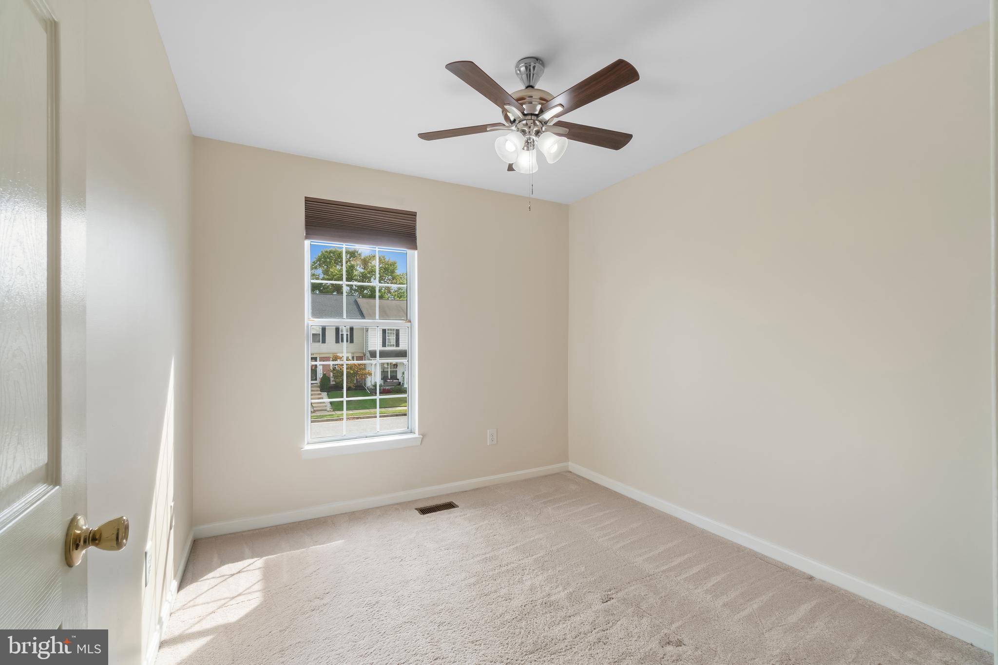 4402 Cole Farm Road Nottingham, MD 21236 - Photo 26 of 42 an empty room with a window and a fan